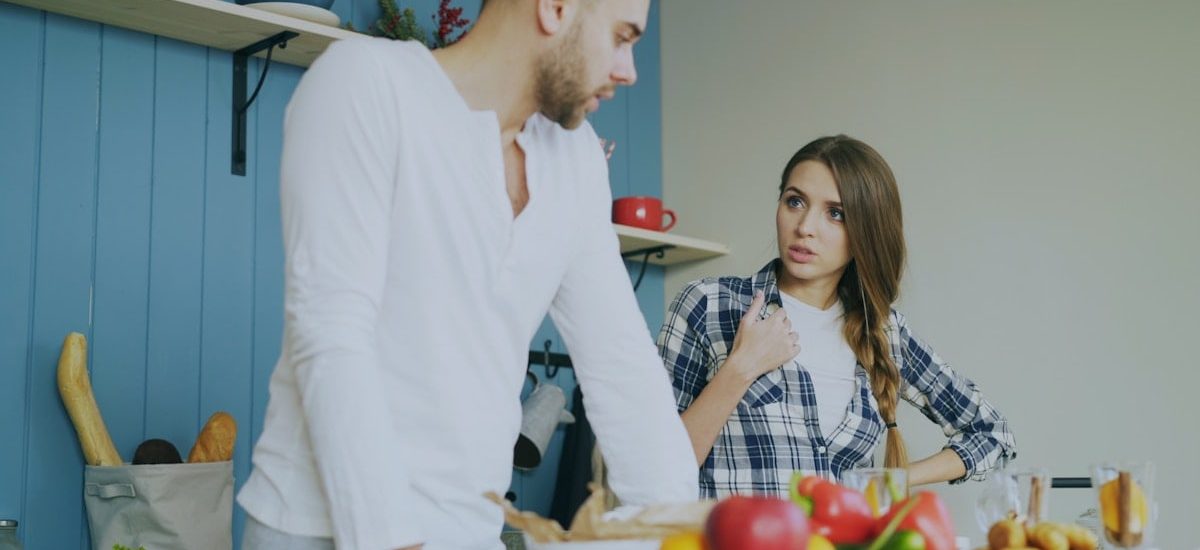 Young couple quarrels in the kitchen during breakfast time in the morning at home