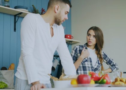 Young couple quarrels in the kitchen during breakfast time in the morning at home